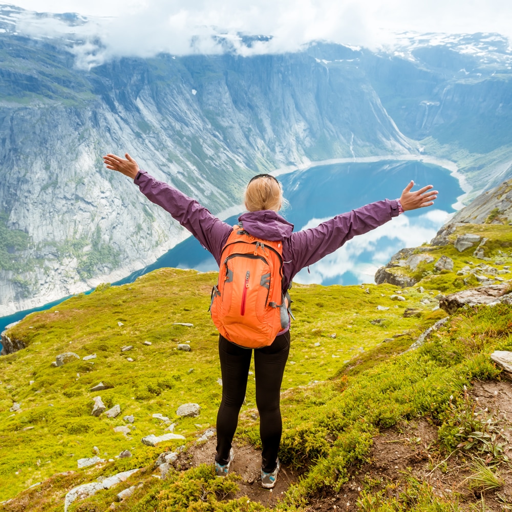 Excited woman on mountain Excited woman on mountain after recovering with hypnotherapy