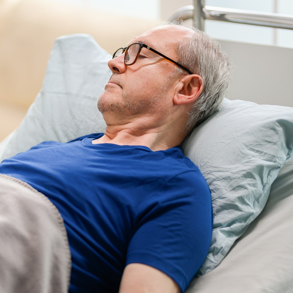 Man with fibromyalgia in bed Man suffering from fibromyalgia in bed