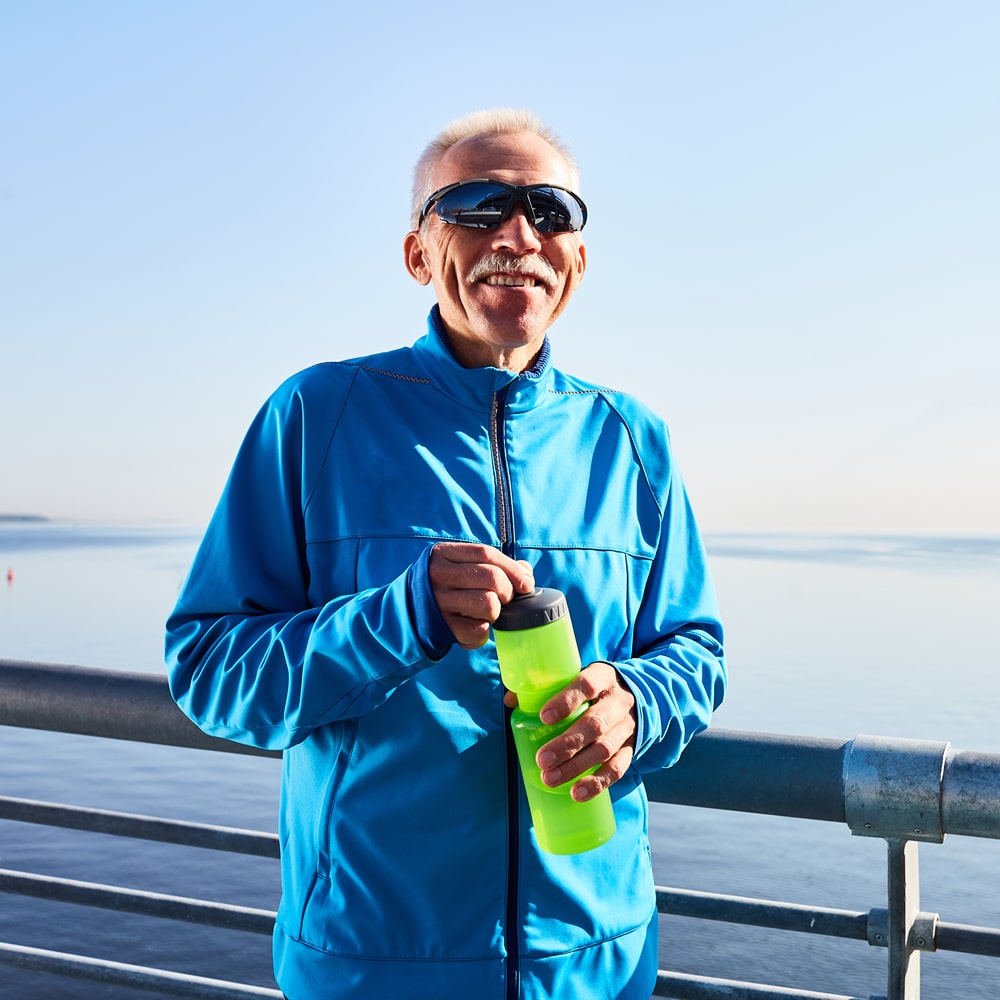 Old jogger smiling in Sydney Old jogger smiling while taking a break in Sydney