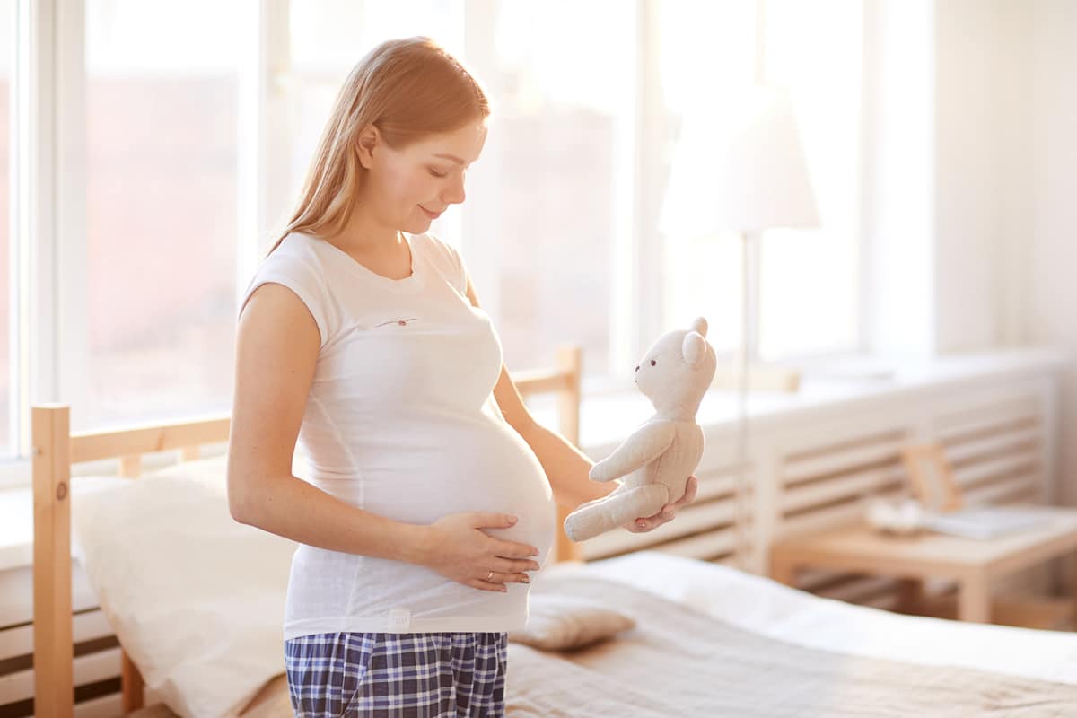 Pregnant hypnobirthing client holding teddy bear Pregnant Hypnobirthing client holding teddy bear near stomach
