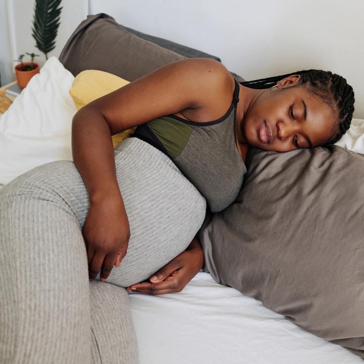 Pregnant woman practicing relaxed breathing in bed Pregnant woman practicing relaxed breathing in bed taught by North Shore & City Hypnotherapy Sydney