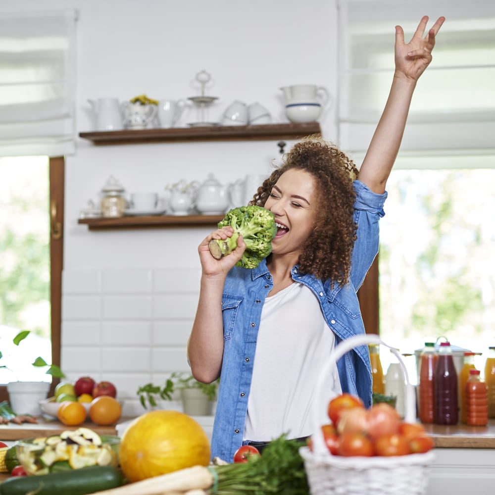 Woman singing in kitchen after IBS recovery Happy woman singing in kitchen after IBS recovery