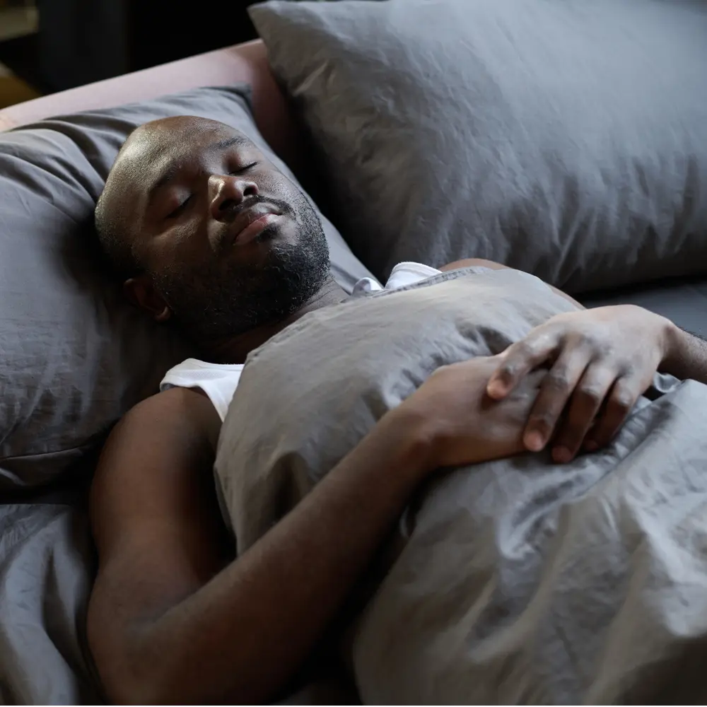 Man in bed after successful hypnotherapy for sleep