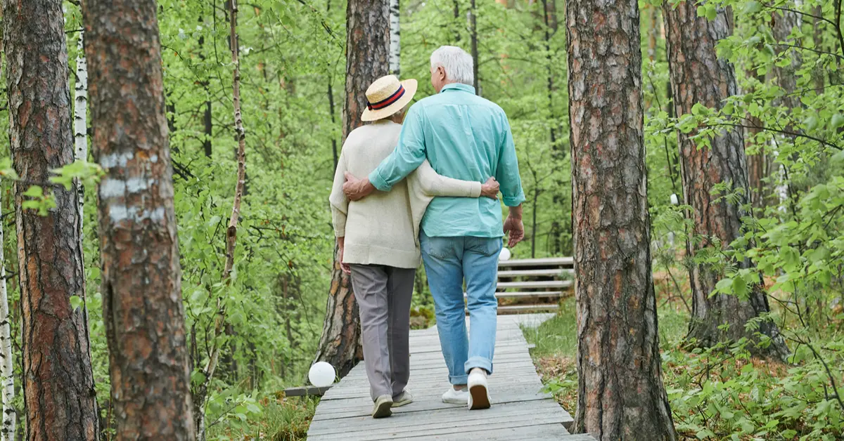 Man & wife walking in park after couples counselling & therapy