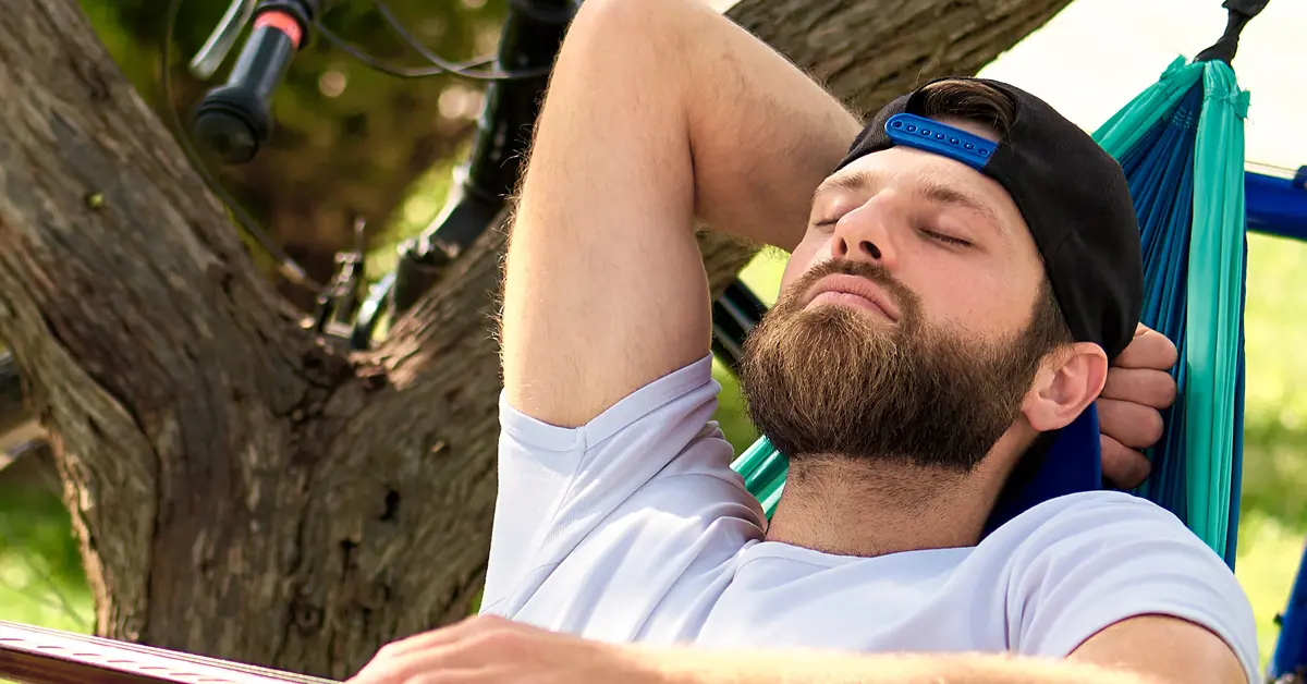 Relaxed man chilling in hammock after hypnotherapy for addiction & bad habit
