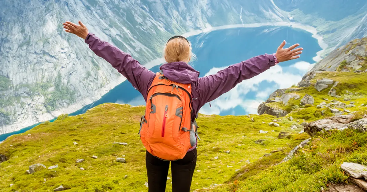 Woman on mountain after recovering with hypnotherapy for chronic fatigue syndrome