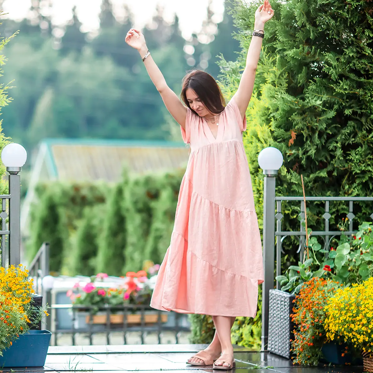 Woman dancing after hypnotherapy for stress management Woman dancing in garden after hypnotherapy for stress management