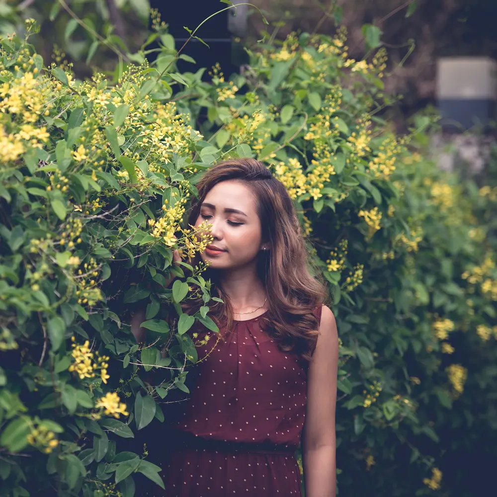 Woman enjoying flowers after hypnotherapy for OCD Woman after hypnotherapy for OCD enjoying scent of flowers