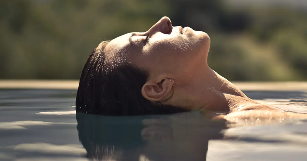 Woman relaxed &  floating in water after clinical hypnotherapy session
